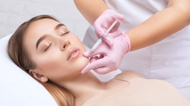 cosmetologist making an injection to a woman