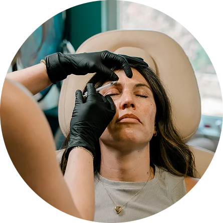 a woman getting her eyebrows done